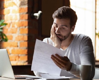 Man reviewing rejected bank application and planning next steps