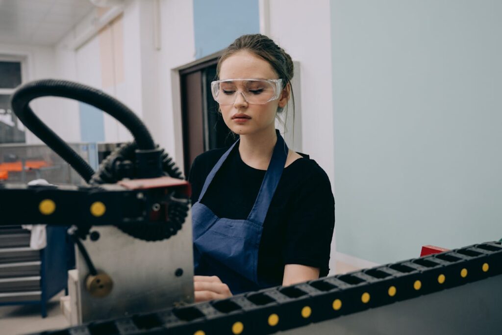 Factory worker operating equipment representing second-chance hiring in manufacturing and production