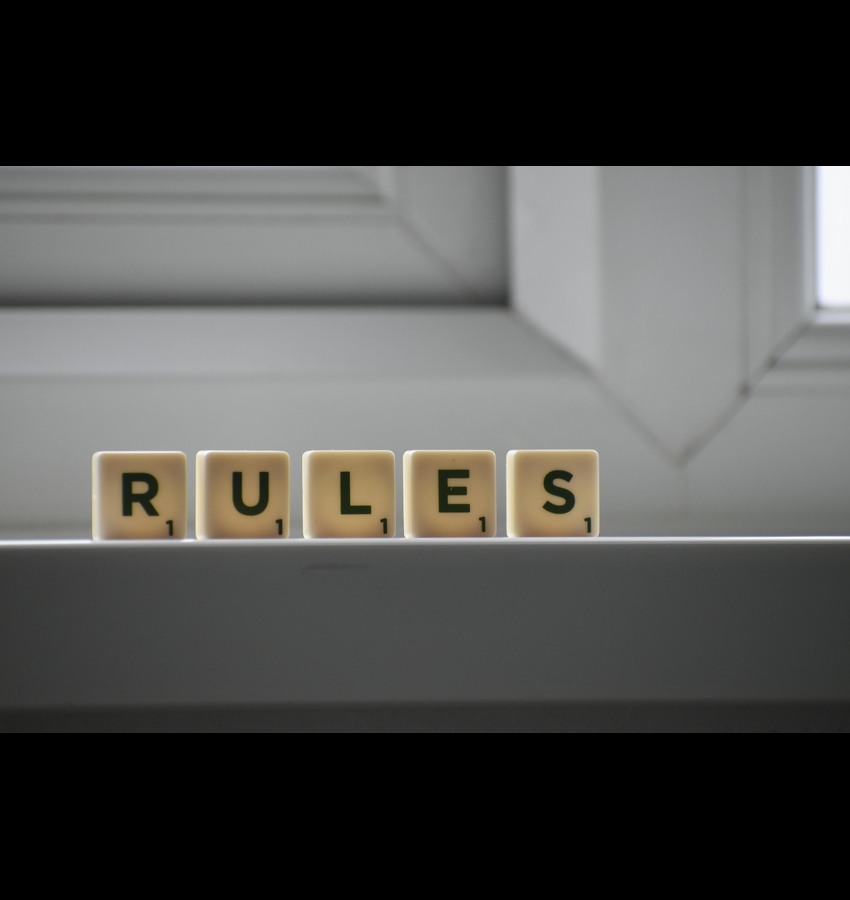 Letter blocks spelling “RULES” representing structure in a sober living home