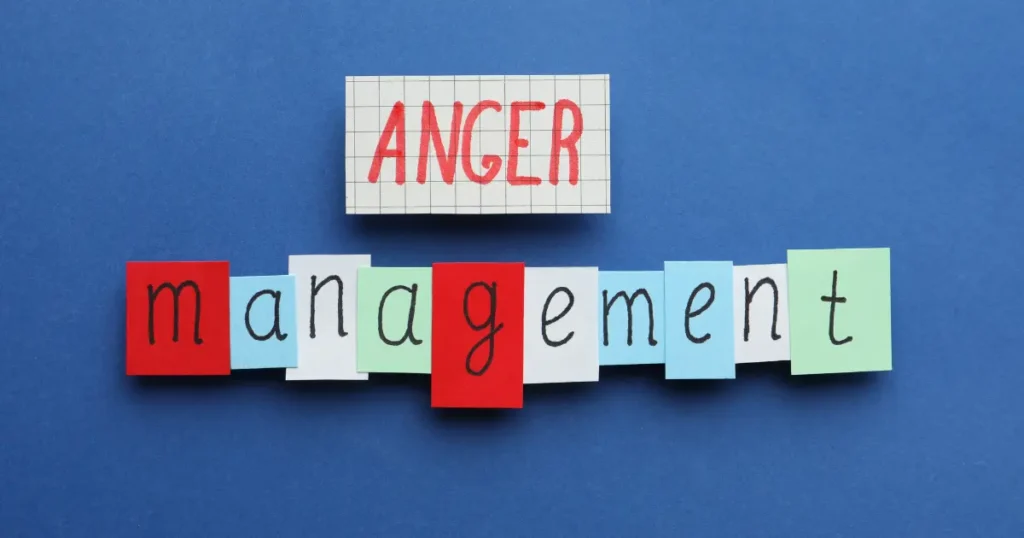 Colorful sticky notes spelling out "anger management" on a blue background