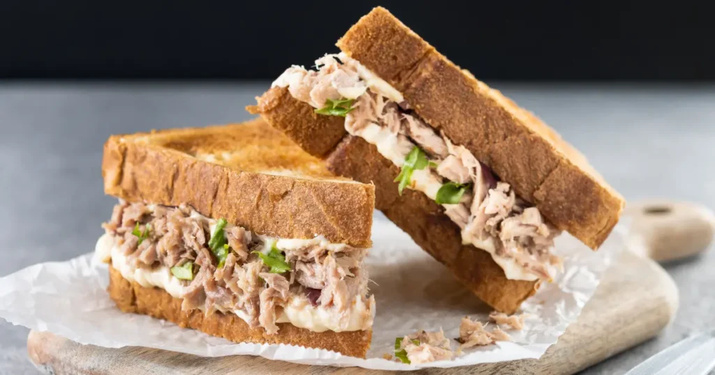 Two tuna sandwiches on toasted bread — affordable high-protein meal option for eating on a tight budget