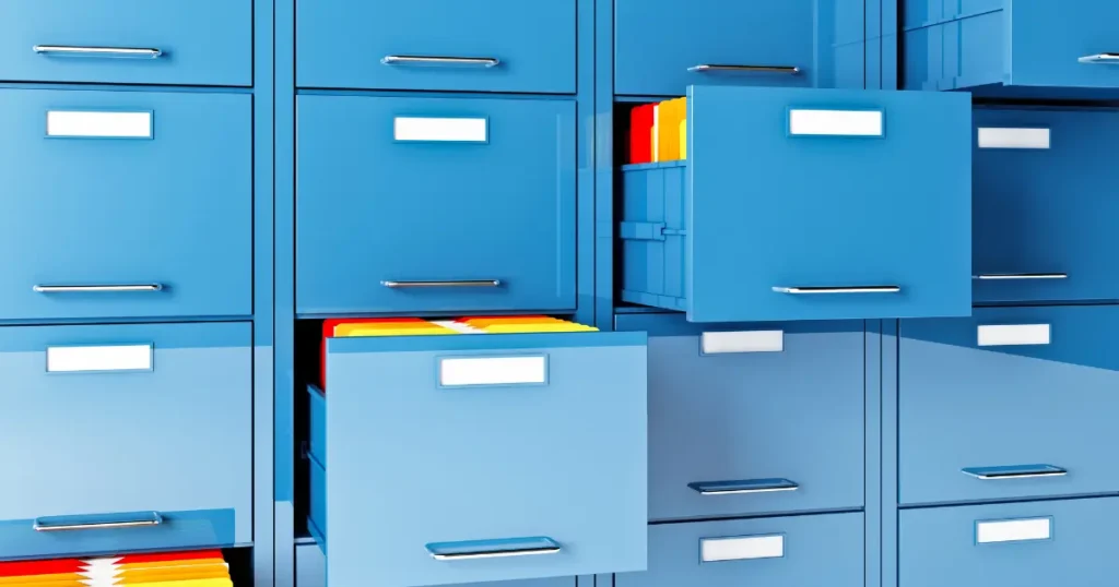 Multiple blue filing cabinets with open drawers containing colored folders — permanent records storage system