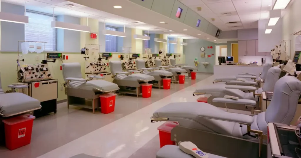 Rows of donation chairs with medical equipment in a plasma donation center