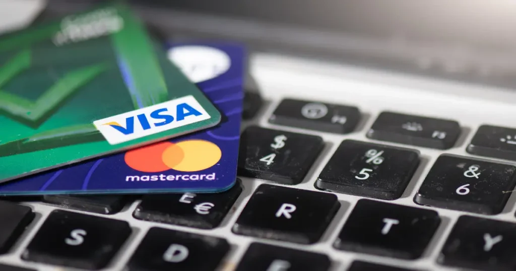 Visa and Mastercard credit cards resting on a laptop keyboard