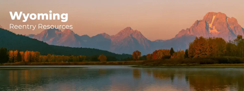 Wyoming reentry resources banner with mountain range and lake at sunset
