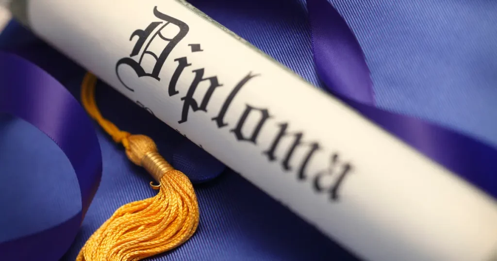 Rolled diploma scroll with gold tassel and purple ribbon representing an educational credential